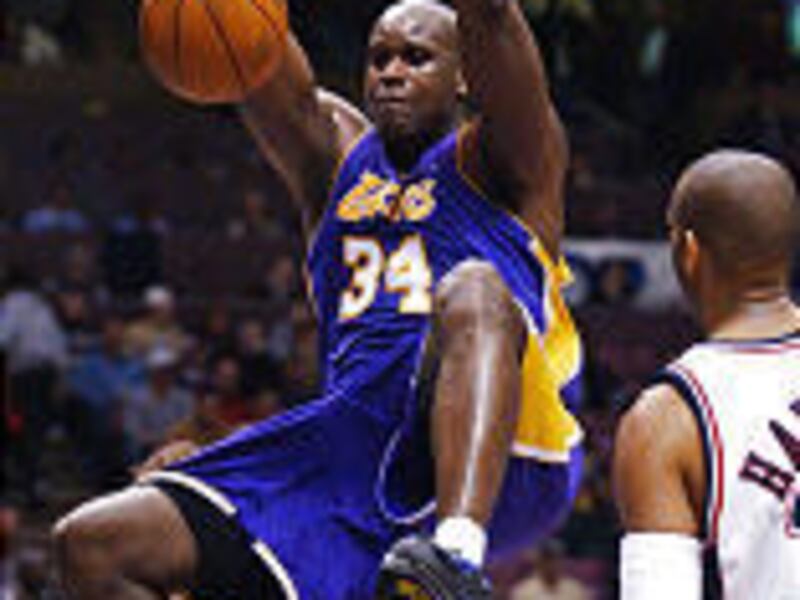 Los Angeles Lakers' center Shaquille O'Neal dunks the ball during the fourth quarter of Sunday's lopsided victory over the New Jersey Nets.