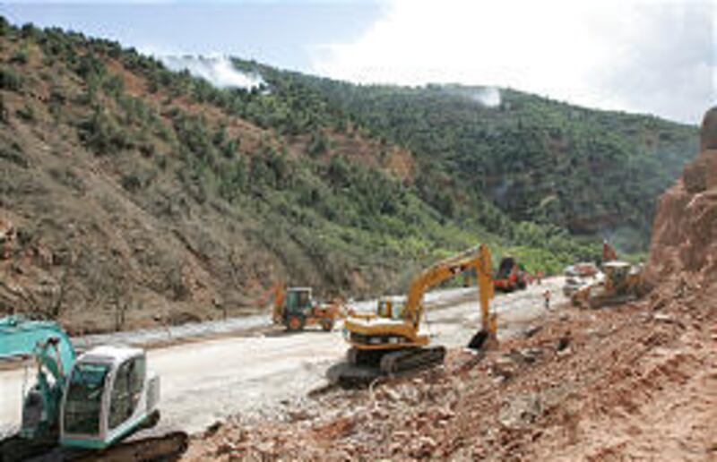 Workers finish grading before resurfacing segment of U.S. 6 in Spanish Fork Canyon that was blasted away.