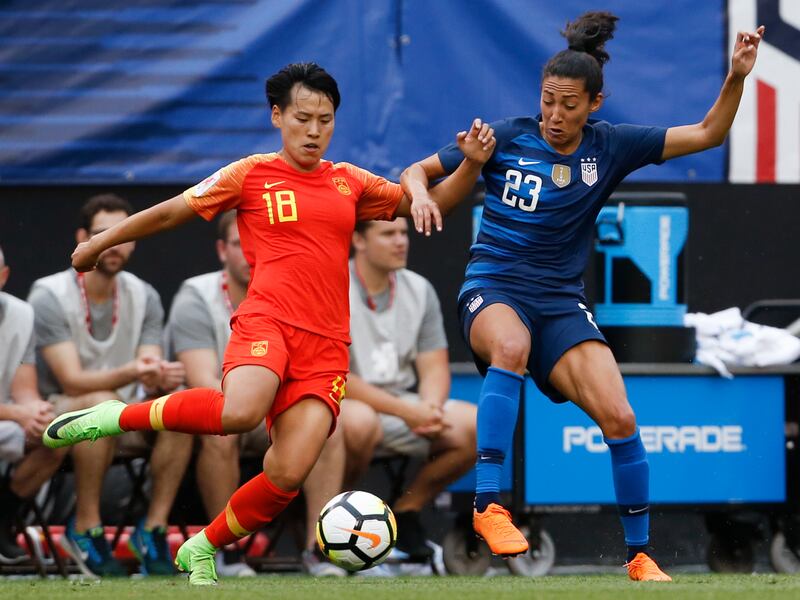 China's Han Peng (18) and United States' Christen Press (23) vie for the ball during the first half during an international friendly soccer match Tuesday, June 12, 2018, in Cleveland. The United States defeated China 2-1. (AP Photo/Ron Schwane)