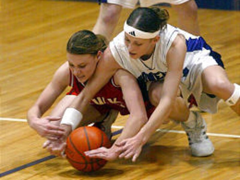 North Sanpete's Kali Larsen, left, and Lehi's Michelle Harrison battle for loose ball during the Pioneers' Region 8-clinching victory on Friday.