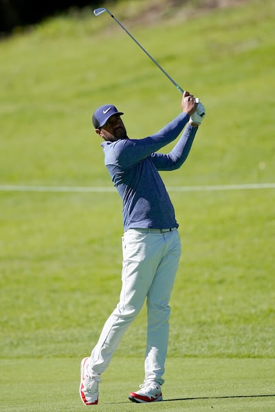 Tony Finau watches his second shot on the 18th hole as second round play continues during the Genesis Open golf tournament at Riviera Country Club on Saturday, Feb. 16, 2019, in the Pacific Palisades area of Los Angeles. (AP Photo/Ryan Kang)