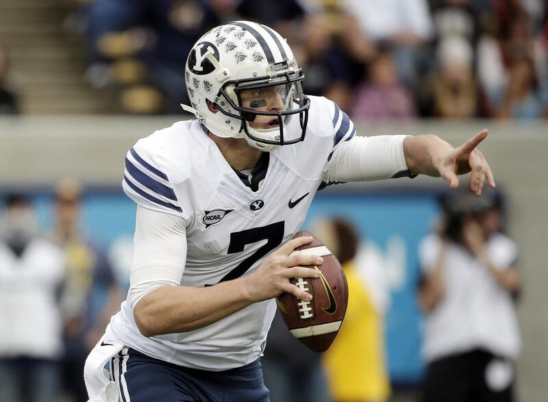 BYU quarterback Christian Stewart directs his team during the first half of an NCAA college football game against California, Saturday, Nov. 29, 2014, in Berkeley, Calif. (AP Photo/Marcio Jose Sanchez)