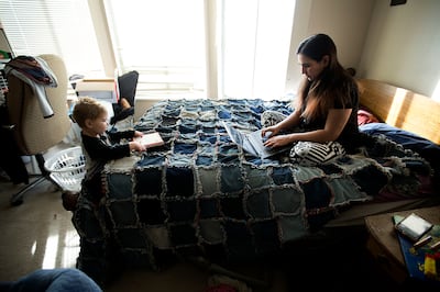 Janci Patterson, a stay-at-home writer, works on her adult romance series called "The Extra" while her son, Kenton, reads at their home in Orem on Friday, Dec. 14, 2018.