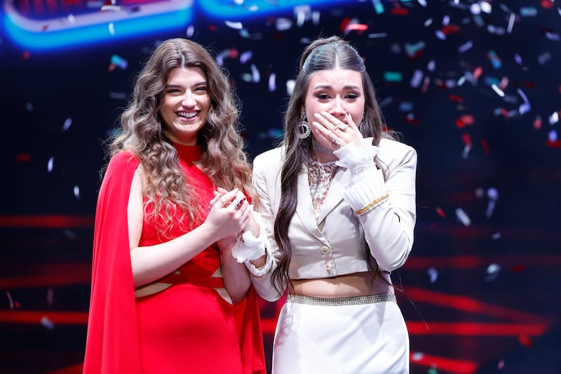 A shocked Gina Miles reacts as she hears the show declare her the Season 23 winner, with Grace West as the runner-up.