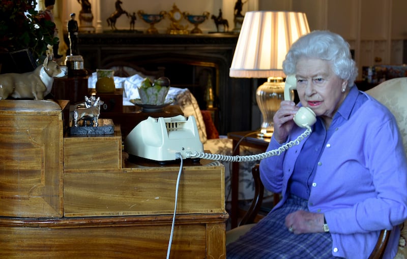 In this photo made available by Buckingham Palace, Britain’s Queen Elizabeth II speaks to Prime Minister Boris Johnson from Windsor Castle, Windsor, England, Wednesday March 25, 2020, for her weekly audience.