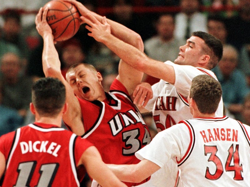 UNLV’s Kaspars Kambala rips down a rebound as Utah’s Alex Jensen reaches for the ball.