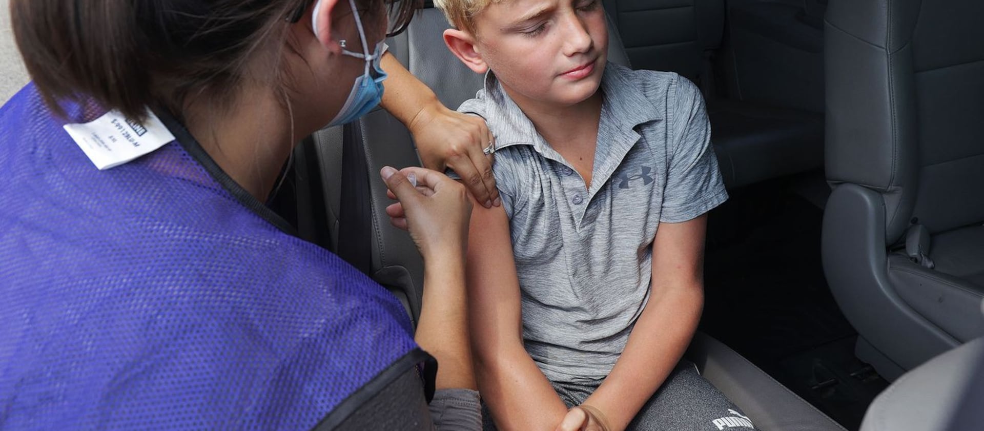 Max Lind, 12, gets a COVID-19 vaccine.
