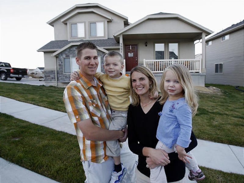 Zac and Heather Nielson, holding Eric and Aubrey, say they were told their home was not part of a homeowners association.
