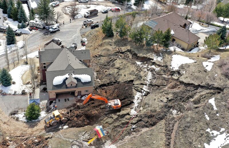 Crews work at the scene of a mudslide near Mountain Green in Morgan County on April 17, 2023.