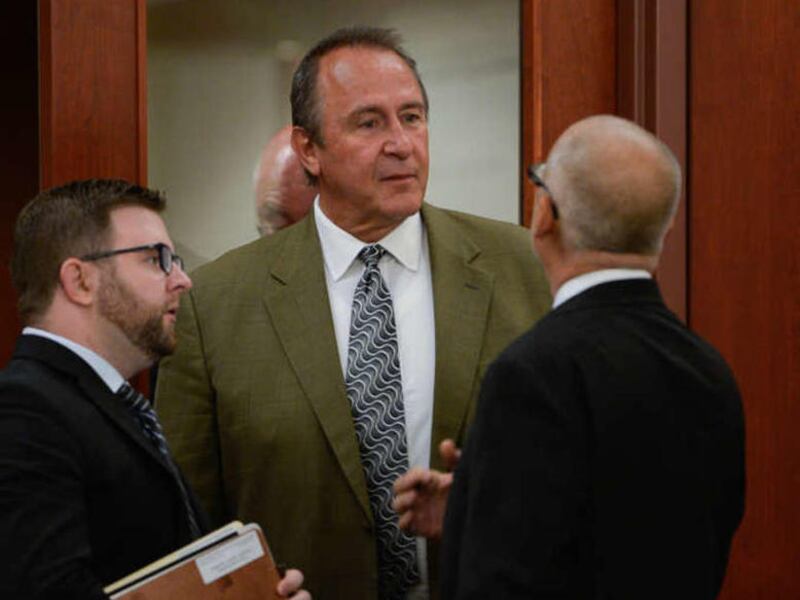 FILE - Former Utah Attorney General Mark Shurtleff, center, facing public corruption charges, appears in Judge Elizabeth Hruby-Mills courtroom in Salt Lake City on Monday, Sept. 28, 2015, for a pre-trial hearing.