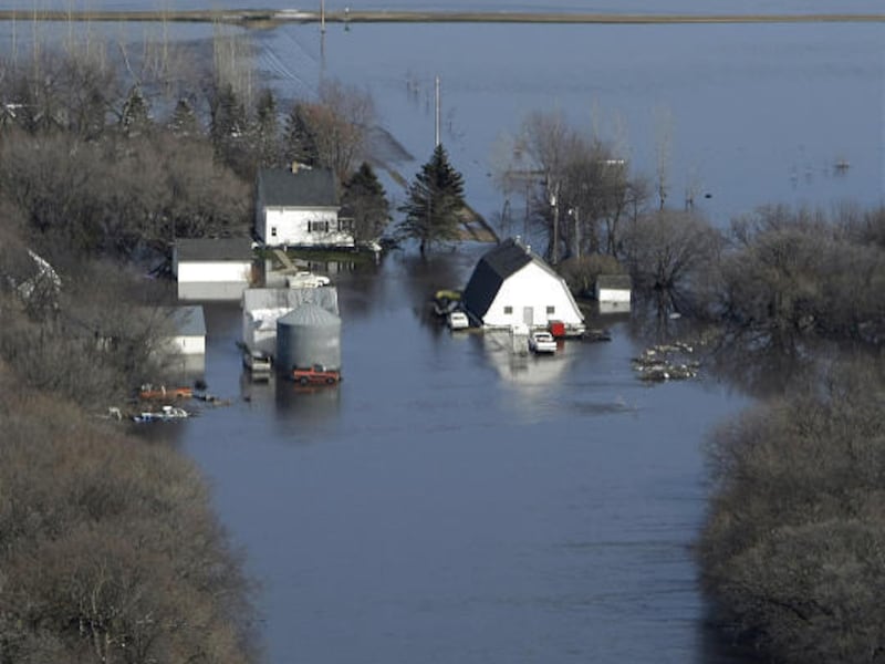 A farm house sits isolated by flood waters last month from the Red River south of Fargo, N.D. Spring floods are receding for now, but farmers and ranchers in North Dakota and northwestern Minnesota are worried that they're on track for a repeat of the dis