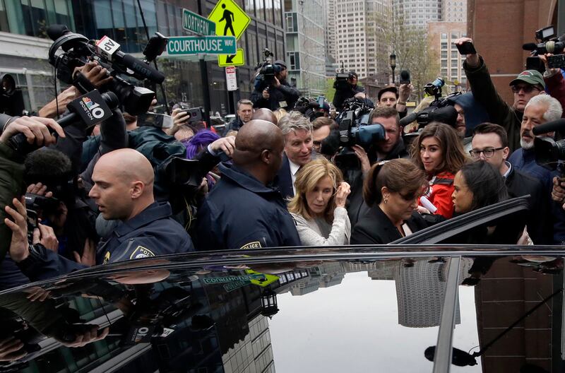 Felicity Huffman, center, gets into a vehicle followed by her brother Moore Huffman Jr., outside federal, Monday, May 13, 2019, in Boston, where she pleaded guilty to charges in a nationwide college admissions bribery scandal.