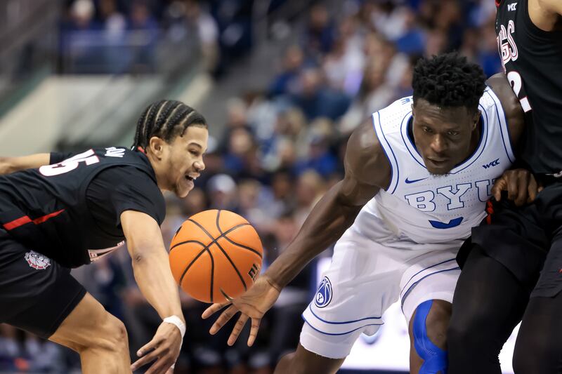Gonzaga guard Rasir Bolton knocks the ball loose from BYU forward Gideon George during game at the Marriott Center.