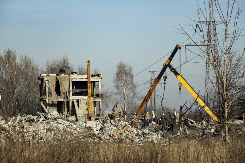 Workers clean rubble after a Ukrainian rocket strike in Makiivka, in Russian-controlled Donetsk region, eastern Ukraine.