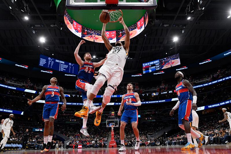 Utah Jazz center Rudy Gobert (27) dunks past Washington Wizards forward Davis Bertans (42), guard Bradley Beal (3), forward Corey Kispert (24) and center Montrezl Harrell (6).