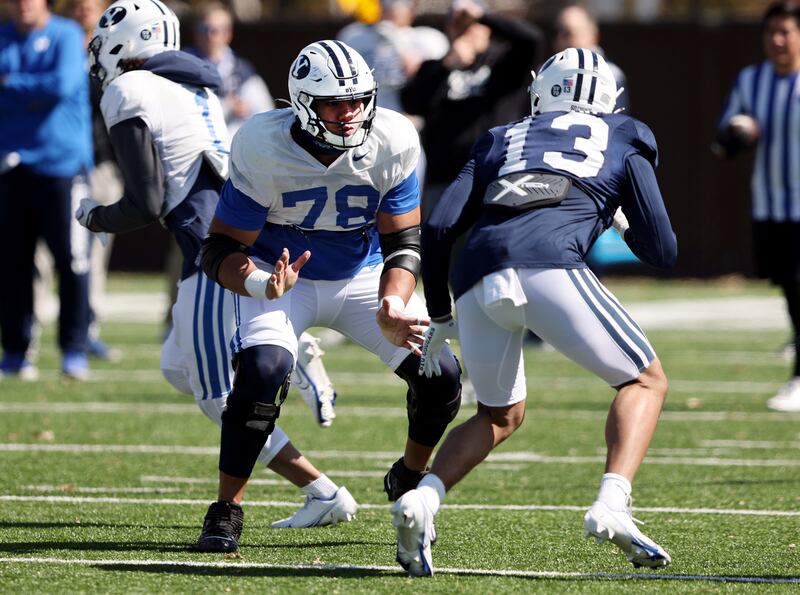 BYU offensive lineman Kingsley Suamataia, left, blocks defensive end Isaiah Bagnah as the Cougars practice in Provo, March 17, 2023.