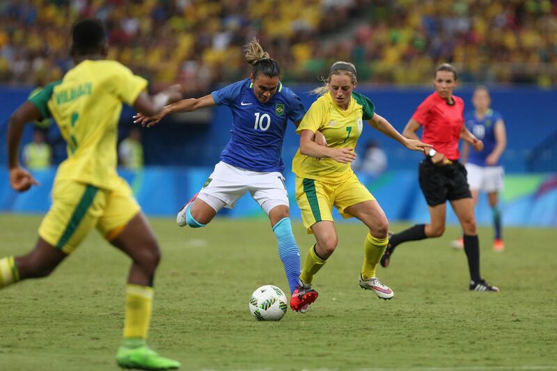 Brazil's Marta, center, and South Africa's Stephanie Malherbe vie for the ball a group E match of the women's Olympic football tournament between South Africa and Brazil at the Arena Amazonia stadium in Manaus, Brazil, Tuesday, Aug. 9, 2016. The game ende