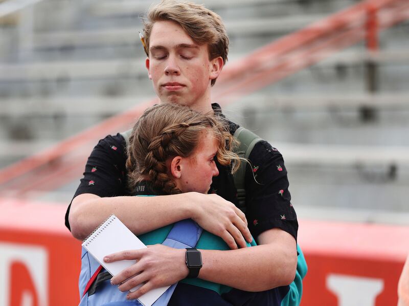 Brighton High school students Parker Olsen and Anna Slagle hug during a student walkout on Wednesday, March 14, 2018 in Cottonwood Heights, Utah. Students across the country planned to participate in walkouts Wednesday to protest gun violence, one month a