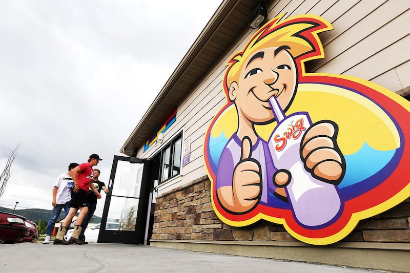Patrons walk into the Swig soda shop in Draper Friday, May 20, 2016.
