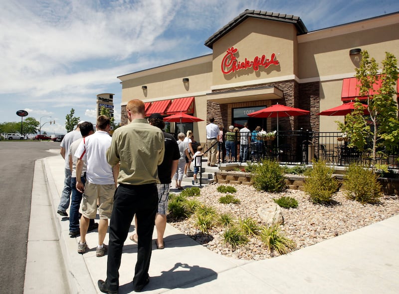 Chick-fil-A customers wait in line to order lunch in Salt Lake County.