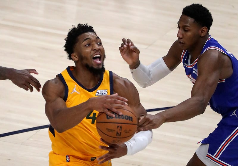 Utah Jazz guard Donovan Mitchell (45) moves around New York Knicks guard RJ Barrett (9) during an NBA game at the Vivint Arena in Salt Lake City on Monday, Feb. 7, 2022.