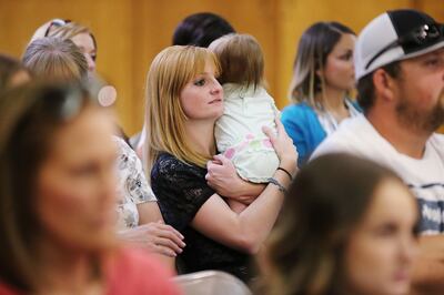 New homeowner Amanda Coppin and daughter Makelle listen during a celebration in Hyrum on Thursday, Sept. 6, 2018, marking the completion of the 400th home in northern Utah through Neighborhood Housing Solutions' Owner-Builder Program. Ten families worked