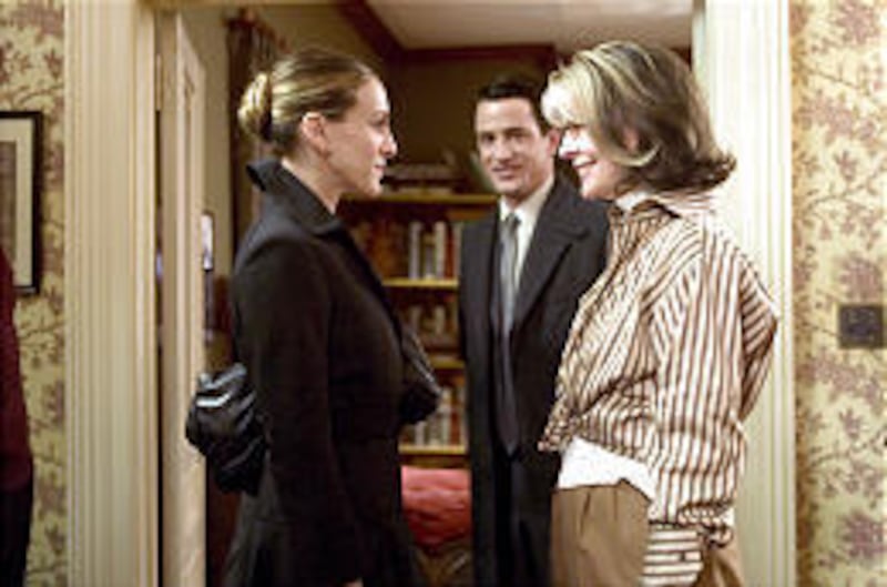 Meredith (Sarah Jessica Parker), left, and Sybil (Diane Keaton) exchange greetings, as Everett (Dermot Mulroney), looks on, in "The Family Stone."