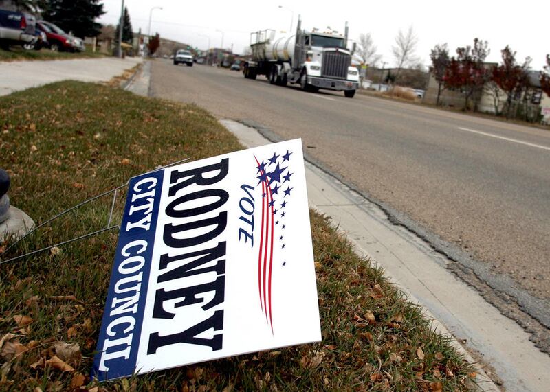 A campaign sign for Duchesne City Councilman Rodney Rowley lies in the grass in front of Duchesne High School, Monday, Nov. 4, 2013. Rowley filed court papers seeking to keep his name on the ballot for the Nov. 5, 2013, general election after he was disqu