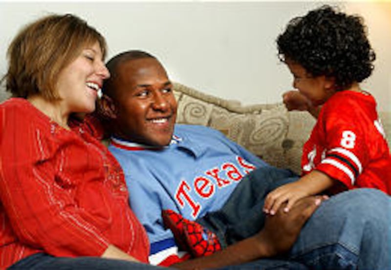 Moa family members Christina, left, Ben and 2-year-old Sione play while watching television in their apartment at the University of Utah.