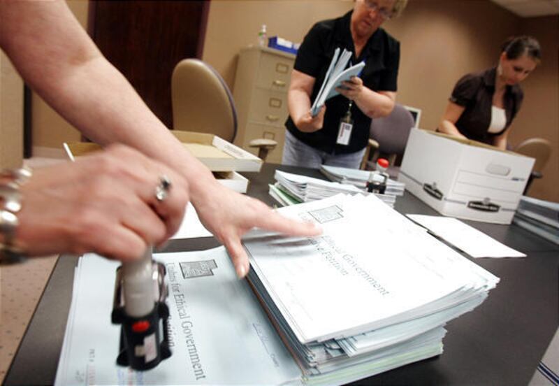 Salt Lake County Clerk's Office elections coordinators process citizen initiative petitions last week.