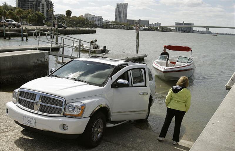 Boaters launch vessels Monday near the dock in Clearwater, Fla., where four men, two current NFL players, and two former University of South Florida football players, left from to go fishing Saturday morning and haven't been heard from since.