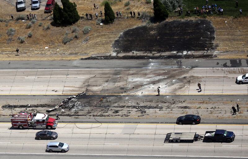 FILE - Scene of a fatal plane crash on I-15 in Riverdale on Wednesday, July 26, 2017. All four people on board died.