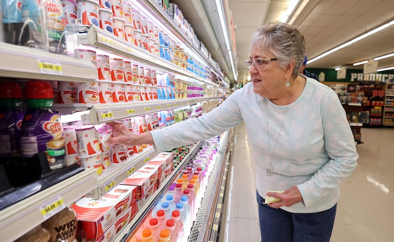 Trudy Cox picks out some yogurt while shopping at Reams on April 4, 2023. As inflation continues on, some items in grocery stores are getting cheaper.