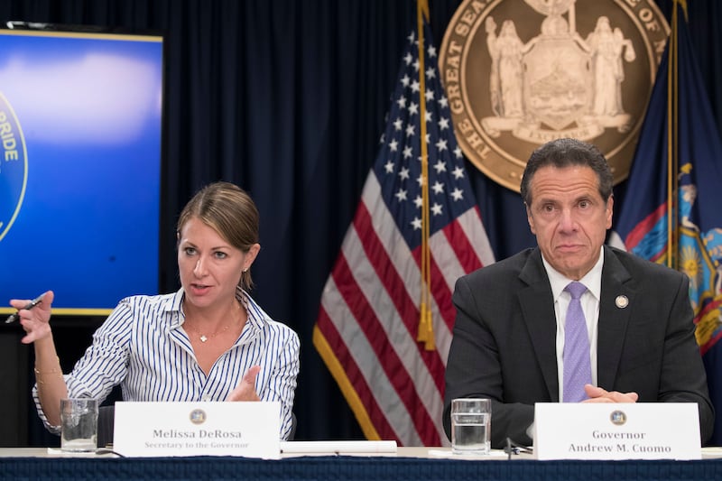 In this Sept. 14, 2018 file photo, Secretary to the Governor Melissa DeRosa, is joined by New York Gov. Andrew Cuomo as she speaks to reporters during a news conference, in New York.