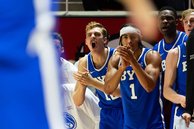 BYU players cheer during game against Utah Utes at the Jon M. Huntsman Center in Salt Lake City on Saturday, Dec. 9, 2023.