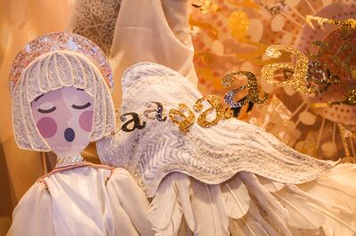A choir of angels in the Grand America Holiday Window Stroll sings a melody of 100 handmade golden notes. This year's 15-window display includes 398 hand-glittered pieces, created from roughly 18 pounds of glitter.
