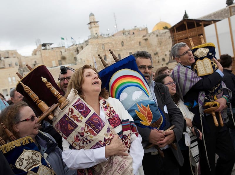 Anat Hoffman (second from left in foreground), chair of Women of the Wall, an activist group that is challenging the Orthodox monopoly over rites at the Western Wall, holds a Torah scroll during a monthly prayer at the site on Nov. 2, 2016. The Western Wa