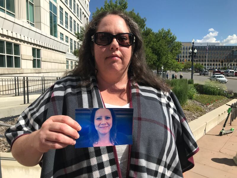 Dawn Hickman poses with a picture of her late sister, Belinda Thomas, outside the Scott M. Matheson Courthouse in Salt Lake Cityon Tuesday, June 4, 2019. Thomas' boyfriend, Darren Fitzgerald Byrd, 50, was sentenced to at least 15 years and up to life in p