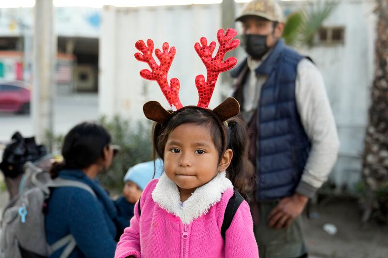 A young girl wears a holiday-themed headdress at an immigration point in Tijuana, Mexico.
