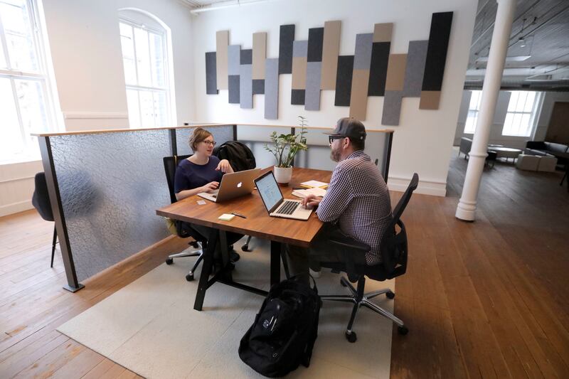BriAnn Denoyer, 3form marketing operations manager, and Adam Wester, 3form art director, work at Impact Hub, a coworking space, in Salt Lake City on Tuesday, Feb. 19, 2019.