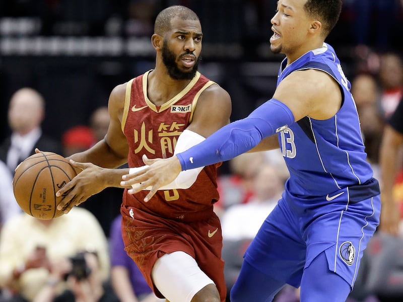 Houston Rockets guard Chris Paul, left, looks to pass as Dallas Mavericks guard Jalen Brunson applies defensive pressure during the first half of an NBA basketball game, Monday, Feb. 11, 2019, in Houston. (AP Photo/Eric Christian Smith)