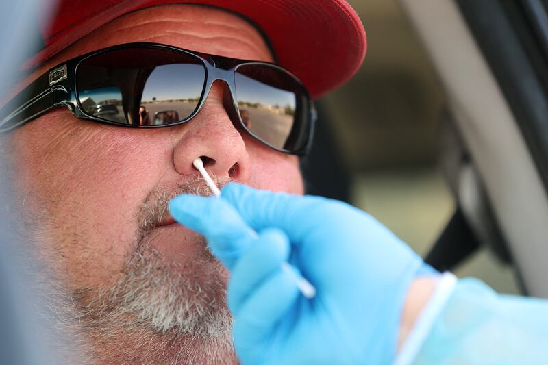 Joe Wright receives a COVID-19 test at the Maverik Center in West Valley City, Utah.