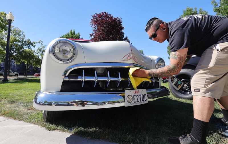 Nick Lobos cleans his 1950 Ford during the Rumble in the Park car show at Pioneer Park in Salt Lake City.