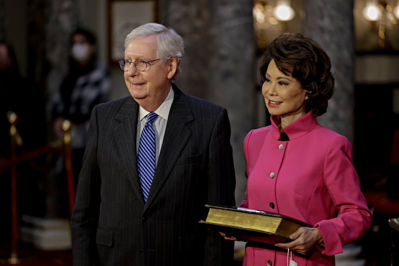 Sen. Mitch McConnell, R-Ky., and his wife Transportation Secretary Elaine Chao, wait for McConnell to be sworn in during a reenactment ceremony in the Old Senate Chamber at the Capitol in Washington, Sunday, Jan. 3, 2021.