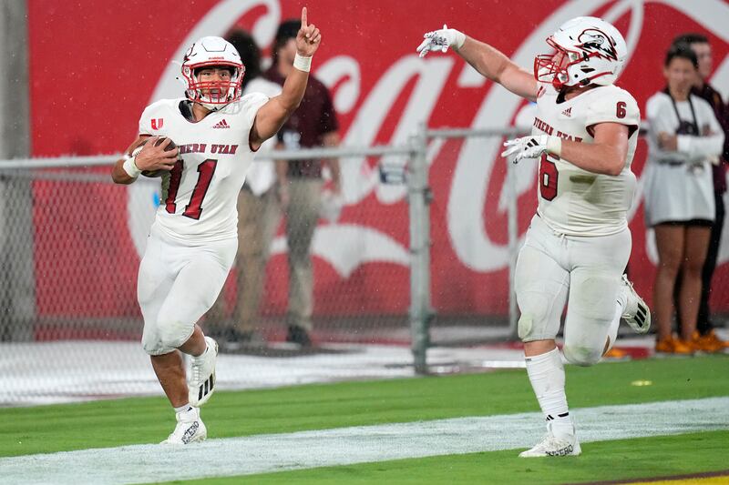 SUU safety George Ramirez celebrates his touchdown after a blocked punt with Southern Utah linebacker Kohner Cullimore.
