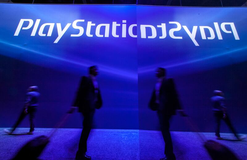 Show attendees walk past the Sony Playstation booth at E3 2012 in Los Angeles, Tuesday, June 5, 2012. The Electronic Entertainment Expo (E3), the premier convention for the computer and video game industry, is returning once again to Los Angeles for its annual gathering from June 5-7. (AP Photo/Damian Dovarganes)