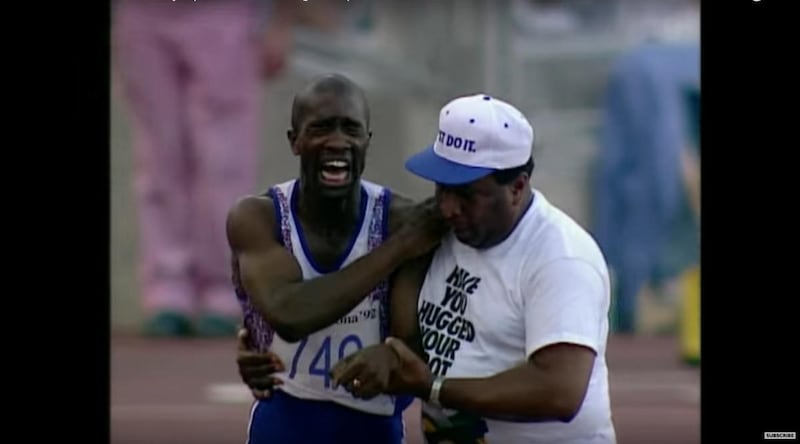 YouTube screen shot of injured Derek Redmond being assisted by his father during 400m semi-finals at Barcelona Olympics.