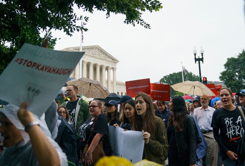 Protesters march from the Supreme Court to the Hart Senate Office Building on Capitol Hill in Washington, Monday, Sept. 24, 2018.