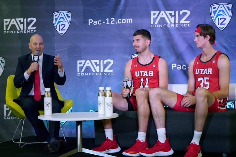 Utah coach Craig Smith, left, speaks next to Riley Battin, middle, and Branden Carlson during Pac-12 media day. Carlson had an appendicitis attack last weekend and will be sidelined for 2-3 weeks, Smith said on Tuesday, January 11, 2022.