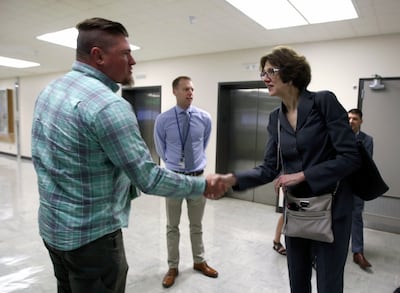 Michael Richardson, director of strategic communications for the U.S. Forest Service, shakes hands with Susan Combs, Interior Department's assistant secretary for policy, management and budget, at the James V. Hansen Federal Building in Ogden on Tuesday,